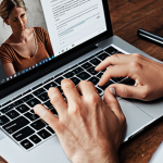 **A person writing an engaging blog post with a laptop, showcasing the importance of human touch and creativity in content creation. The scene should convey empathy and connection.**